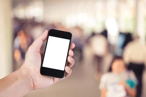 Person using smartphone white screen holder on hand with  many people walking Stock Photos