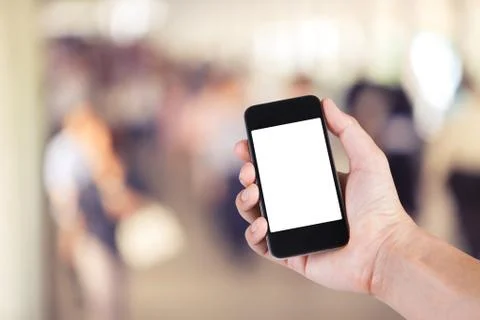 Person using smartphone white screen holder on hand with  many people walking Stock Photos