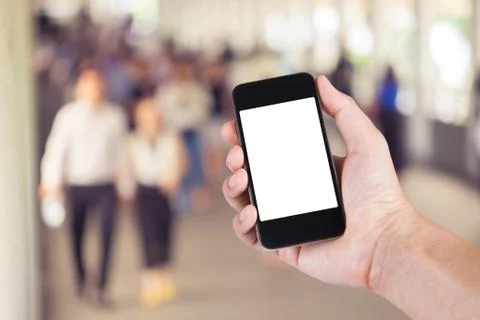 Person using smartphone white screen holder on hand with  many people walking Stock Photos