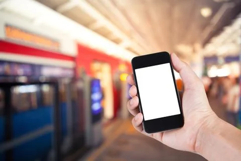 Person using smartphone white screen holder on hand with  blurred background  Stock Photos