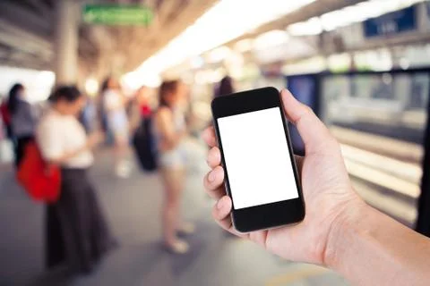 Person using smartphone white screen holder on hand with  blurred background  Stock Photos