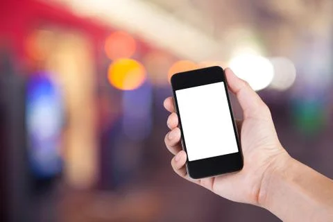 Person using smartphone white screen holder on hand with  blurred background  Stock Photos