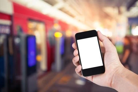 Person using smartphone white screen holder on hand with  blurred background  Stock Photos