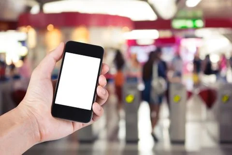 Person using smartphone white screen holder on hand with  blurred background  写真素材