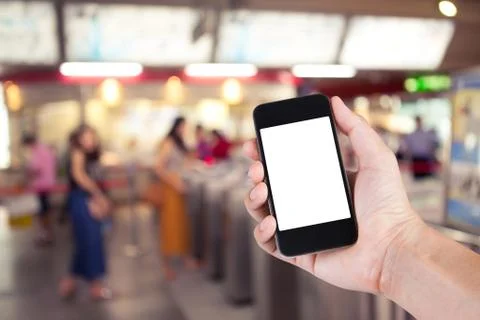 Person using smartphone white screen holder on hand with  blurred background  Stock Photos