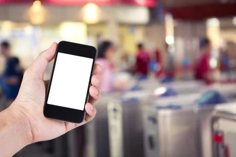 Person using smartphone white screen holder on hand with  blurred background  Stock Photos