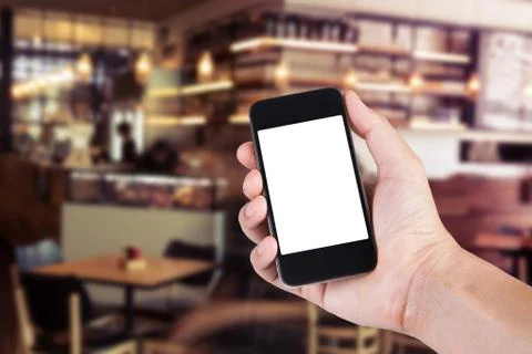 Person using smartphone white screen holder on hand with blurry background of 写真素材