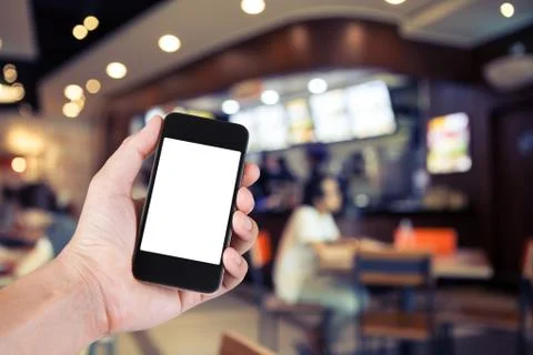 Person using smartphone white screen holder on hand with blurry background of Stock Photos