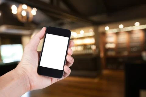 Person using smartphone white screen holder on hand with blurry background of Stock Photos