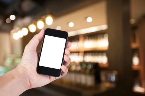Person using smartphone white screen holder on hand with blurry background of Stock Photos