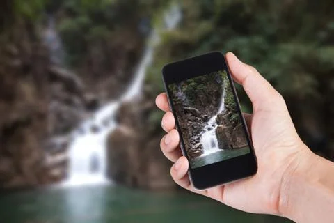 Person using smartphone white screen holder on hand with blurry background of Stock Photos