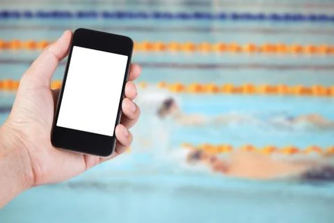 Person using smartphone white screen holder on hand with blurry of swimming p Stock Photos