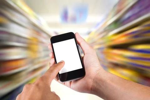 Person using smartphone white screen holder on hand with shelves on backgroun Stock Photos