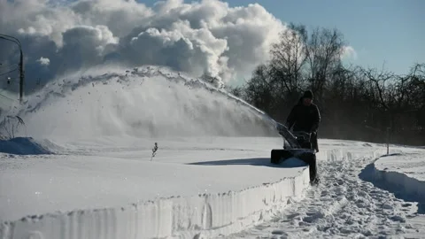 Person using snow blower after heavy snowfall Видео 156545540