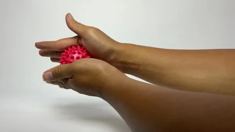 Person Using Spiky Sensory Ball for Hand Rehabilitation Exercise Stock Footage 329610760