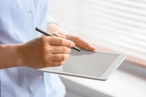 Person using stylus on digital tablet Stock Photos