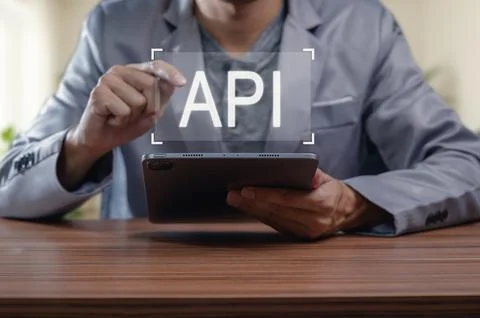 Person Using Tablet to Access API in Modern Digital Interface Foto stock