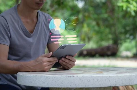 Person Using Tablet to Access Personal Information Outdoors Stock Photos