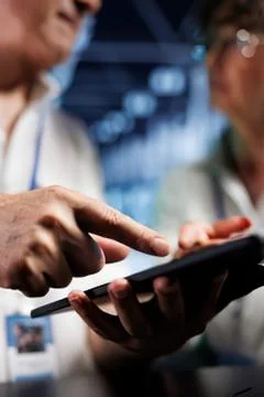 Person using tablet and smartphone at event Stock Photos