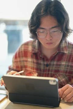 Person using tablet at cafe table Stock Photos