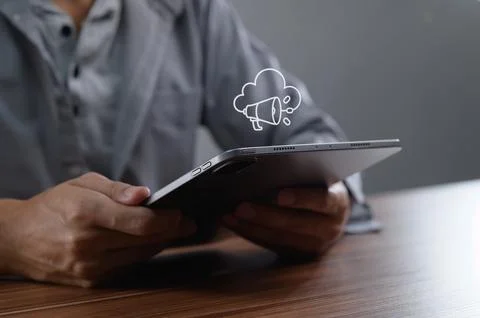 Person Using Tablet with Cloud Icon and Notification Symbol Stock Photos