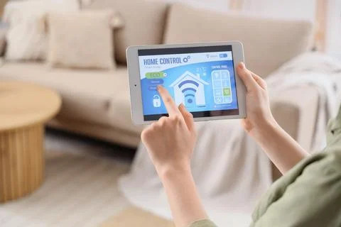 Person using tablet to control smart home system Stock Photos
