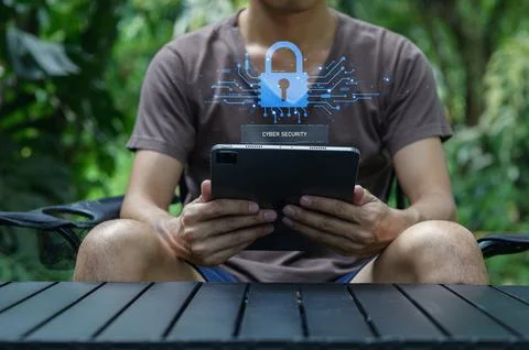 Person Using Tablet with Cyber Security Concept in Nature Setting Stock Photos