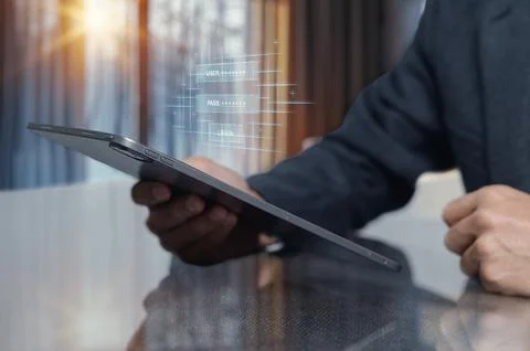 Person Using Tablet Device with Digital Interface and Security Elements Stock Photos