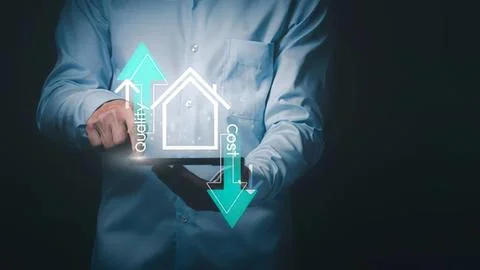 Person using tablet with digital house and arrow icons 스톡 사진