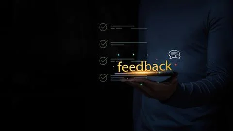 Person using tablet with feedback icons in dark setting Stock Photos