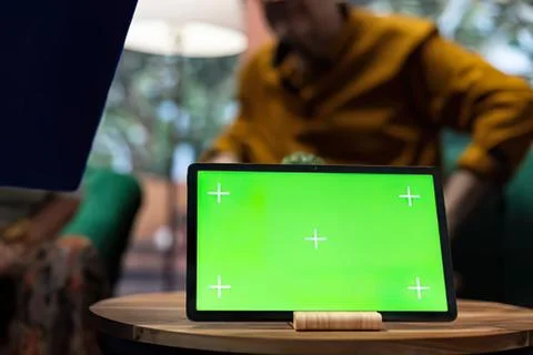 Person using tablet with green loading screen Stock Photos