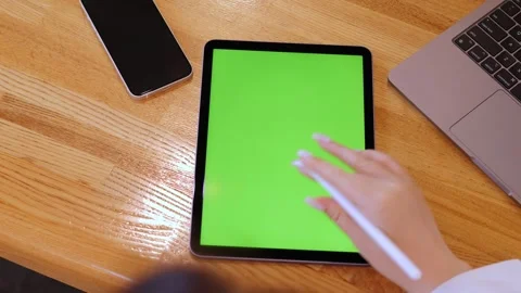 Person is using a tablet with a green screen Stock Footage 319436591