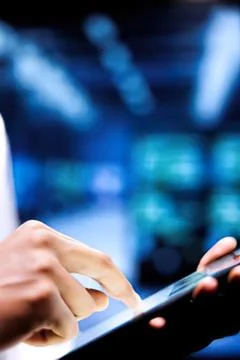 Person using tablet in modern office setting Stock Photos