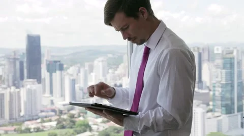 Person Using Tablet PC Looking Out Of Office Window Video stock 57649542