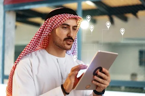 Person using a tablet to plan taxi routes in a busy travel area with navigation Stock Photos