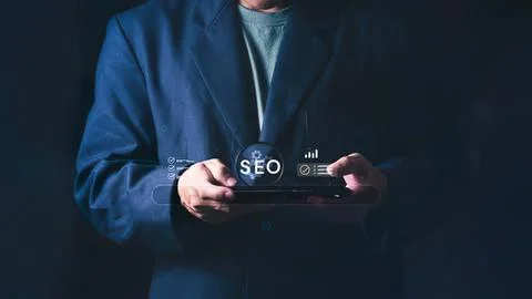 Person using tablet with seo and digital icons Stock Photos