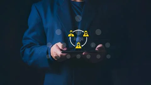 Person using tablet with social network icons in dark Stock Photos