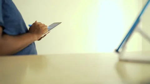 Person Using Tablet with Stylus on Desk Stock Footage 320725147