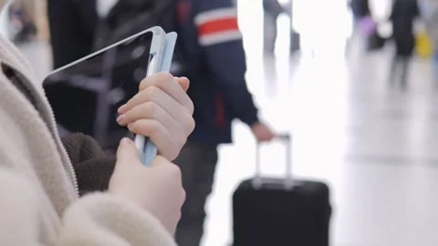 Person using tablet while waiting at airport 库存影片 340939256