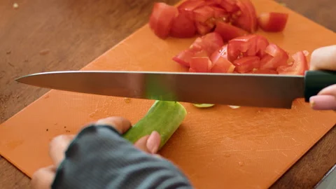 Person using tableware cuts vegetables and plants on wooden board for recipe Stock Footage 271224635