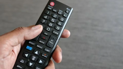 Person using television remote control to change channels and navigate smar.. Stock Footage 333030349
