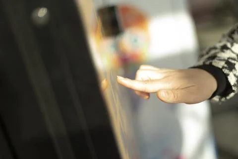 A person is using their finger to press a button on a machine Stock Photos