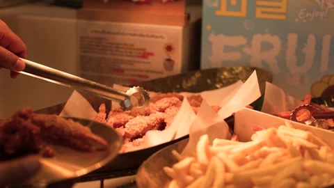 Person Using Tongs to Pick Fried Shrimp at a Buffet Stock Footage 340244172