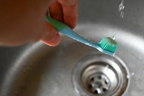 A person is using a toothbrush to clean the teeth Stock Photos