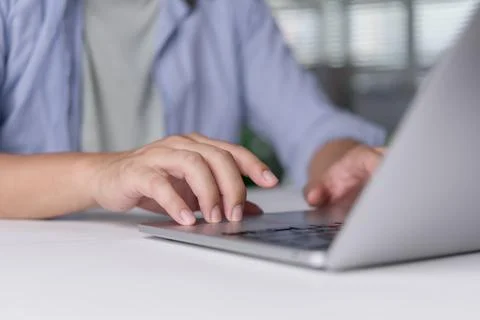 Person using touchpad laptop browsing web content website. Student learning.. Stock Photos