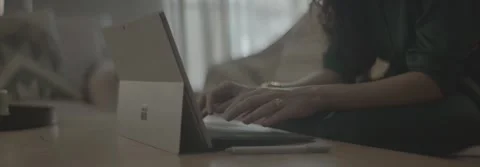 Person using a touchscreen laptop with a stylus on a coffee table. Stock-Footage 330240111