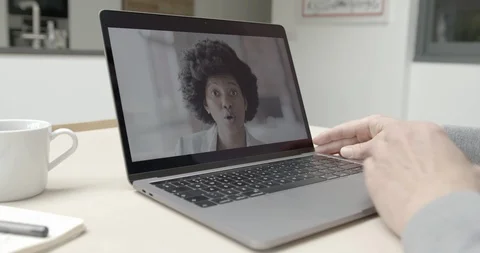 Person Using Video Conferencing technology in kitchen for video call with friend Video stock 127854638