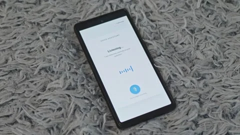 Person using voice assistant app on smartphone, pressing microphone button on Stock Footage 341569495