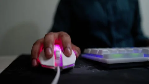 Person using a white gaming mouse with RGB lighting Stock Footage 317737403