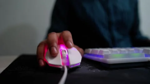 Person using a white gaming mouse with RGB lighting Stock Footage 317737409